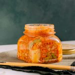 Fermented vegetables including kimchi in glass jar for digestion support.